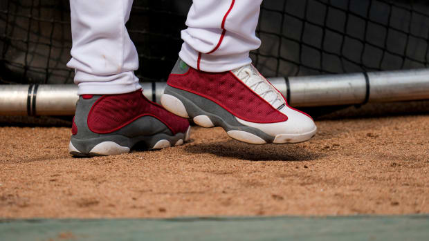 View of Elly De La Cruz's red and grey Air Jordan shoes.